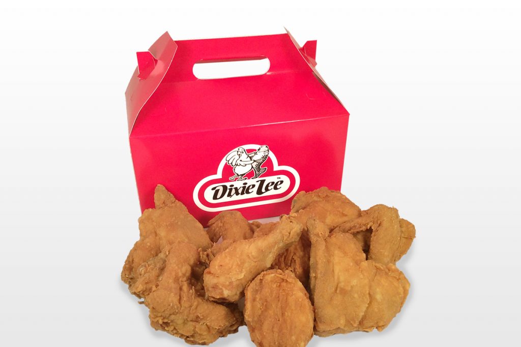 Red takeout box with fried chicken pieces.