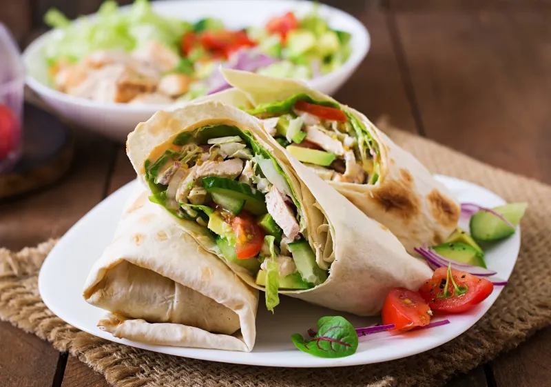 Premium Taste tortilla wraps Fried Chicken Fast Food Restaurant, Fresh tortilla wraps with chicken and fresh vegetables on plate