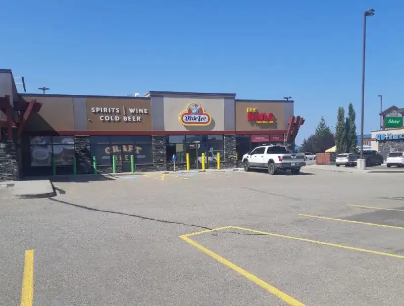 Parking lot in front of liquor store and restaurants.